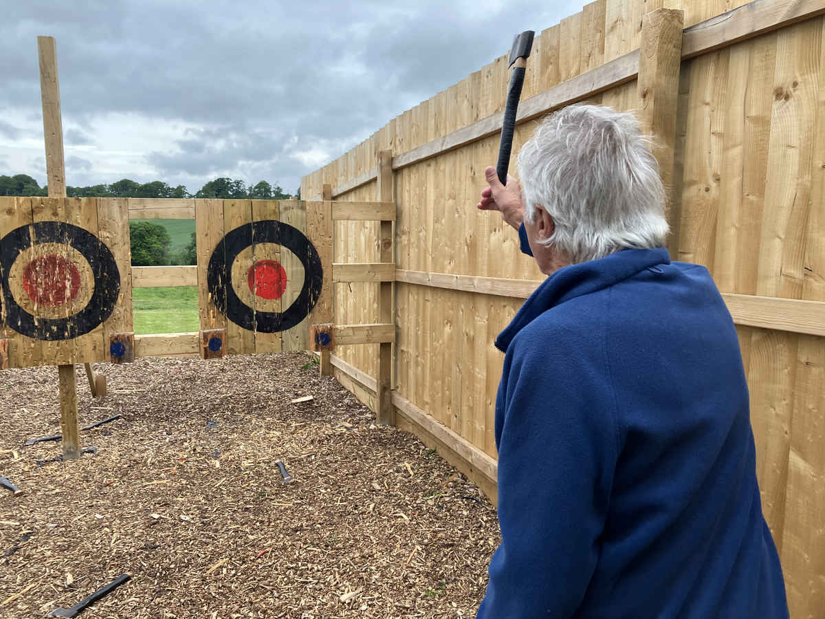 Participant aiming an axe towards the targets near Exeter