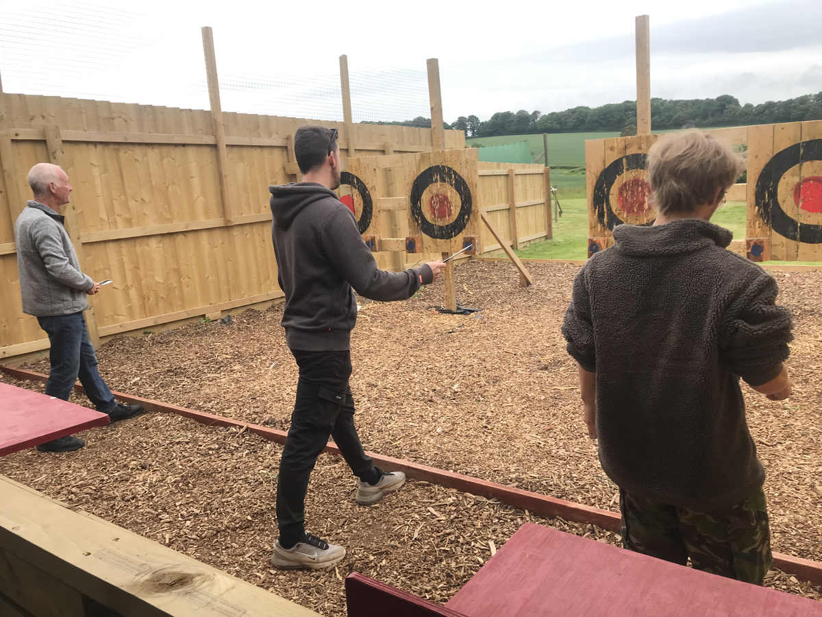 Group practising their throwing skills in the outdoor lanes