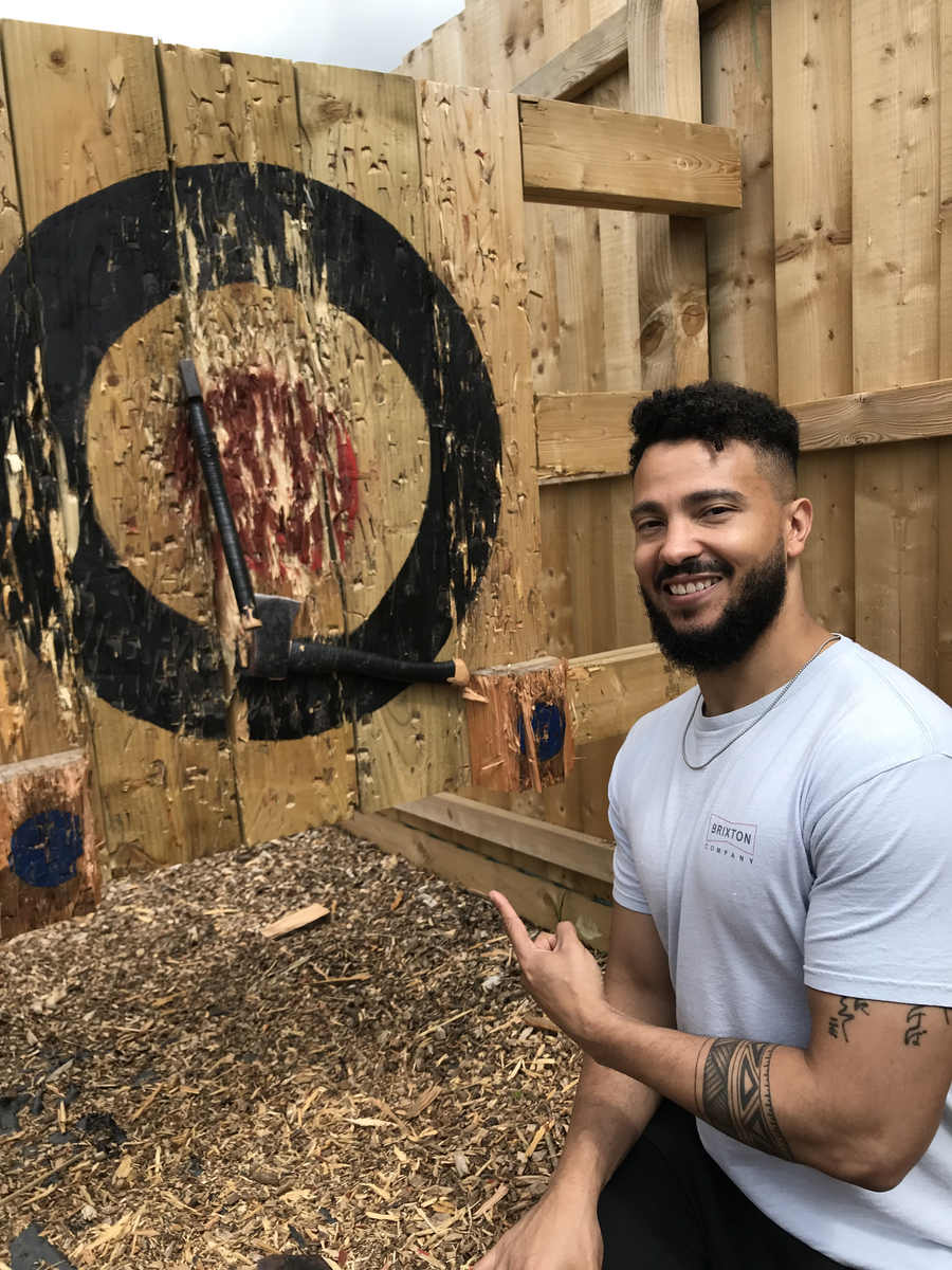 Participant beside a target with axes embedded in it