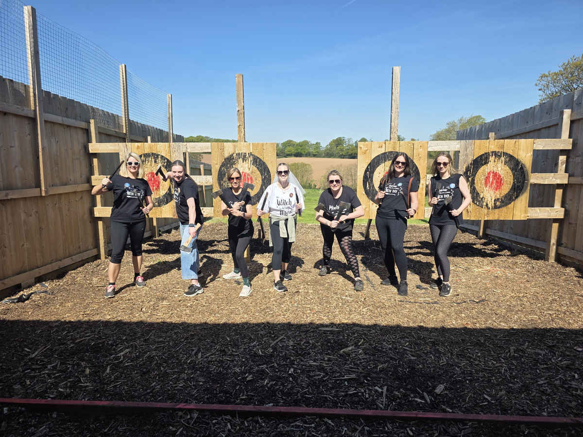 Hen party posing with throwing equipment beside the targets